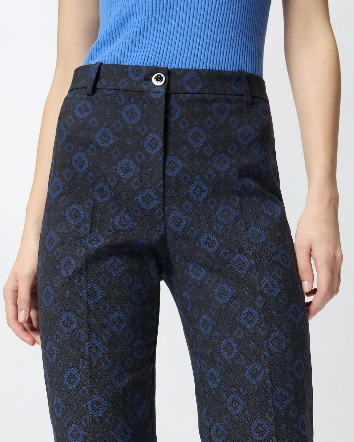 Trousers with a geometric and floral motif