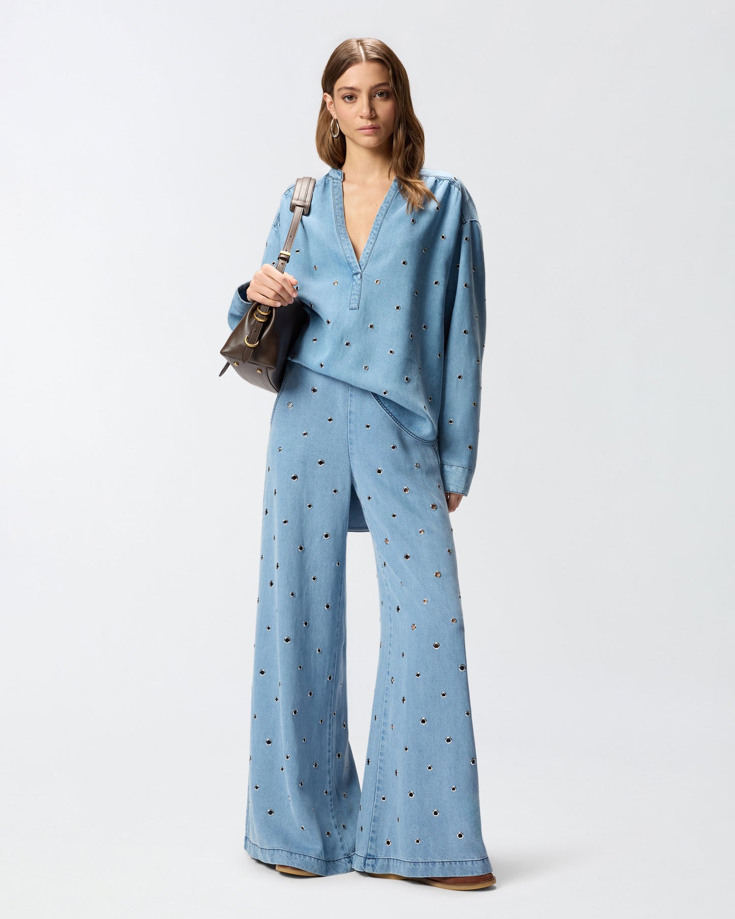 Denim jeans with eyelets