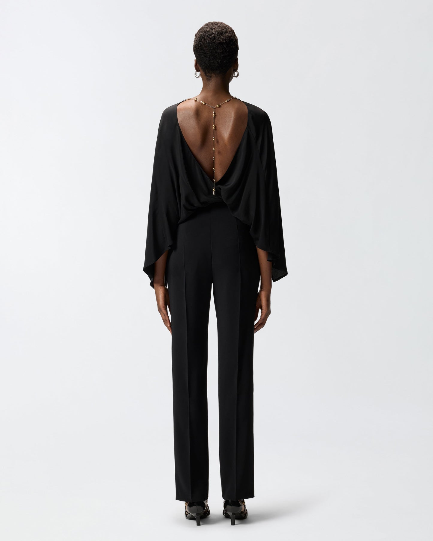 Long playsuit with exposed back and jewel necklace